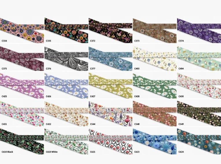 Vibrant collection of printed Biothane dog collars in diverse floral and patterned designs, showcasing customisable options for every style.