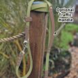 Avocado-coloured BioThane multi-way double-ended lead with optional traffic handle and brown BioThane accents, displayed on wooden post.