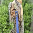 Aubreys x Lutchfords collaboration BioThane lead in navy blue and beige with antique brass hardware, displayed on weathered wood.