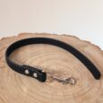 Black Super-Grip Waterproof Training Tab Obedience Lead with textured grip handle and nickel hardware, displayed on natural wood.