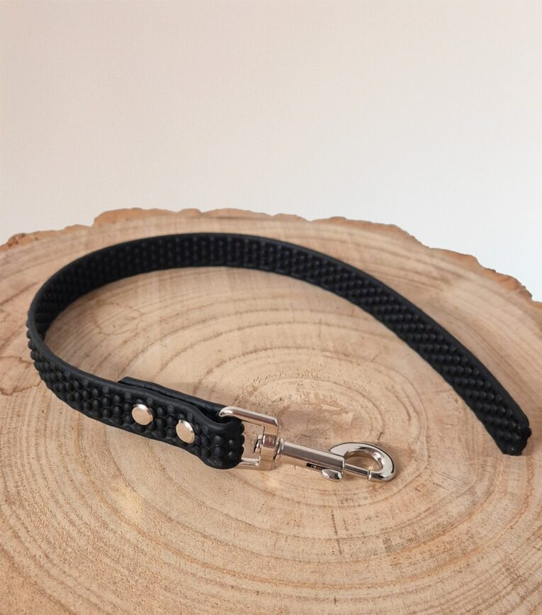 Black Super-Grip Waterproof Training Tab Obedience Lead with textured grip handle and nickel hardware, displayed on natural wood.