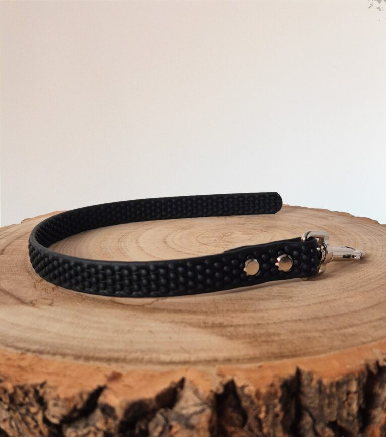 Black Super-Grip Waterproof Training Tab Obedience Lead displayed on natural wood, showcasing textured grip surface and antique brass hardware.