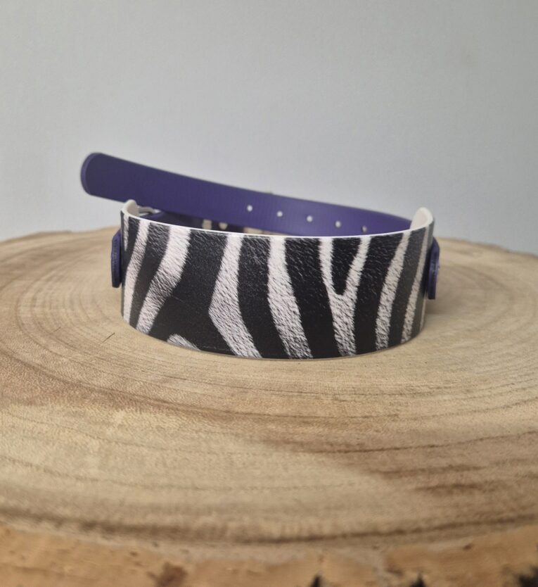 Zebra-striped printed tapered hound collar in black and white with navy BioThane backing and hardware.