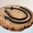Black Super-Grip Waterproof Training Tab Obedience Lead coiled on wood, showing textured grip finish and nickel hardware.