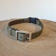 Waterproof BioThane quick-snap customisable dog collar strap with nickel hardware, displayed on natural wood.