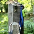 Aubreys x Lutchfords collaboration paracord lead with navy blue BioThane and antique brass hardware, displayed on wooden post.